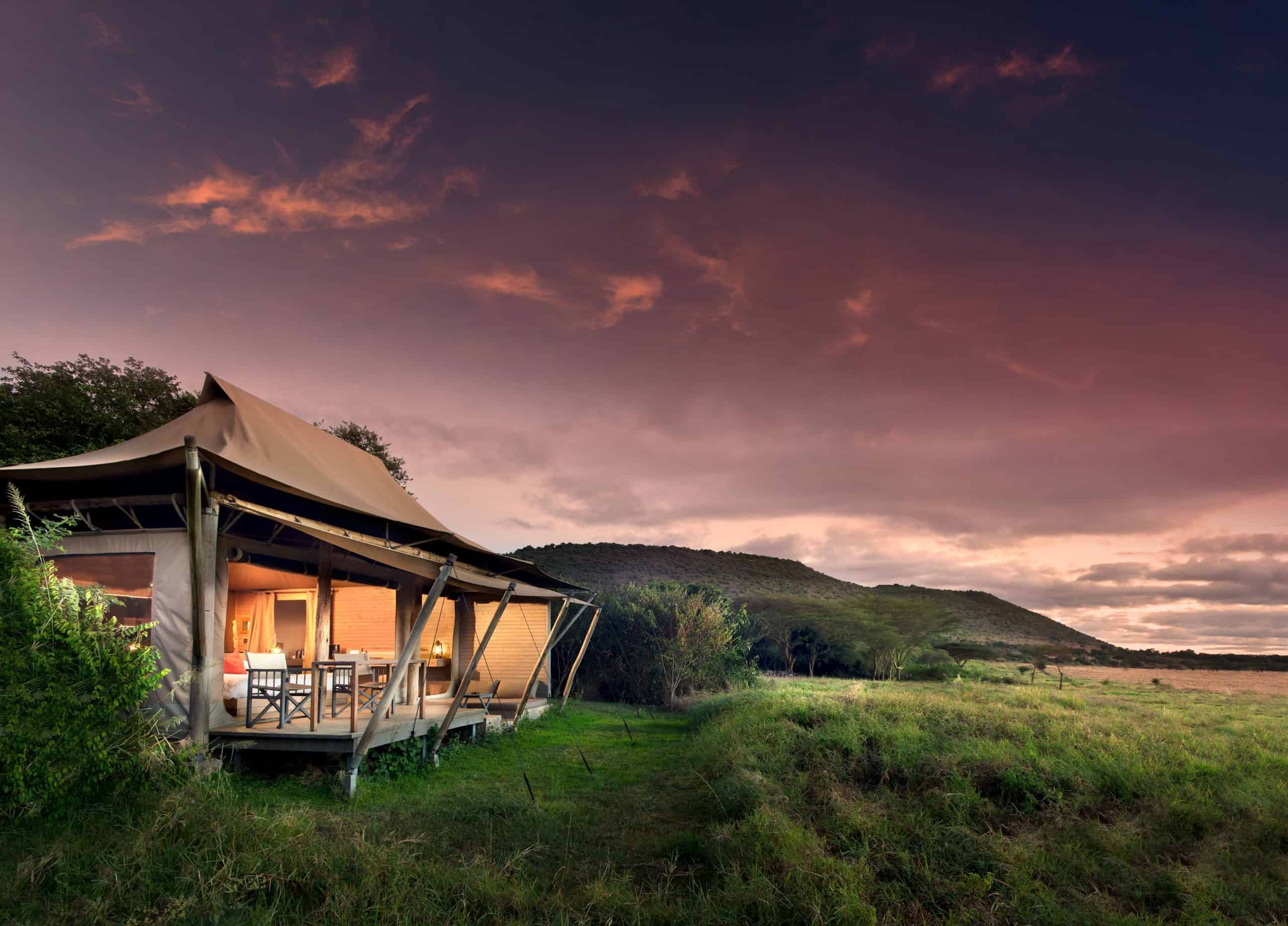 Safari tents at sunset overlooking the Masai Mara, Kenya