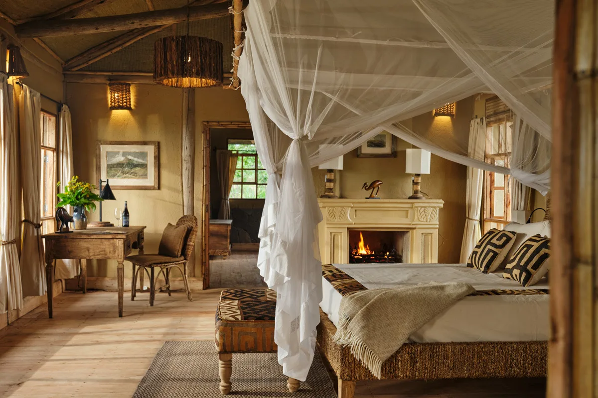 Four-poster bedroom with fireplace, Kibale Lodge, Uganda