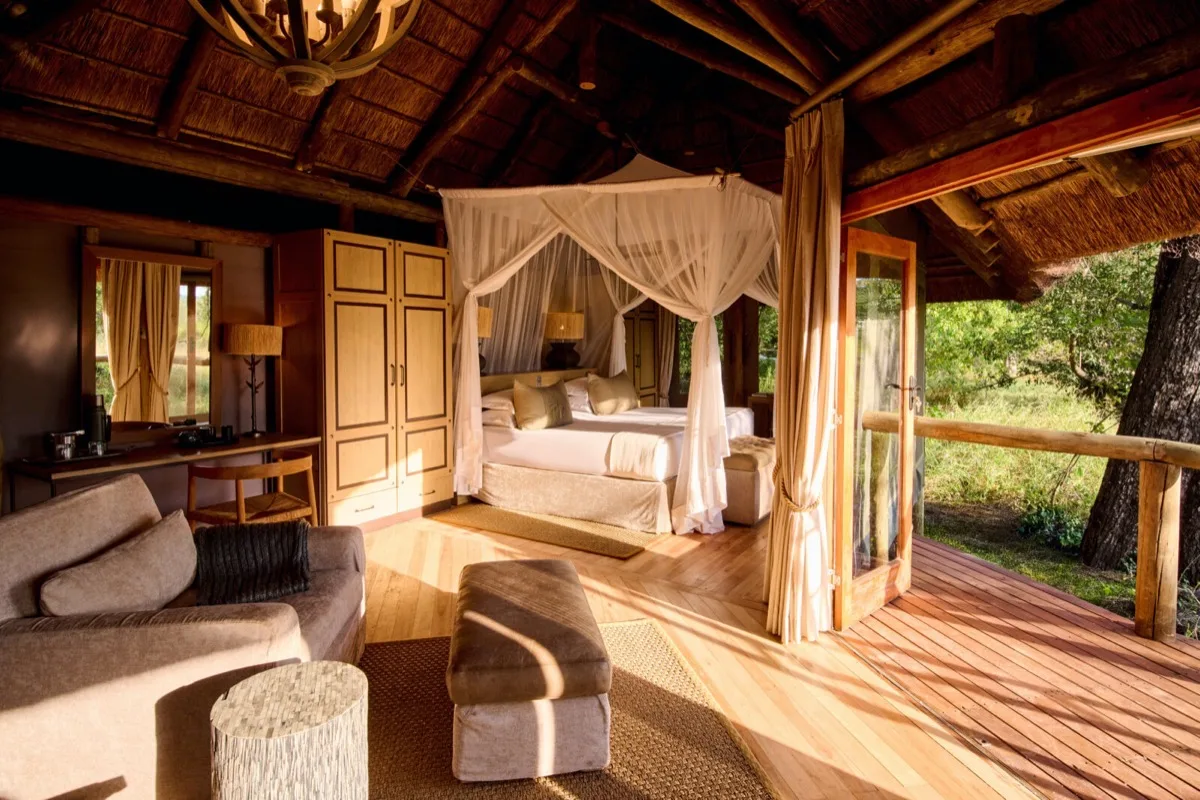 Safari suite with four-poster bed, Camp Moremi, Moremi Game Reserve