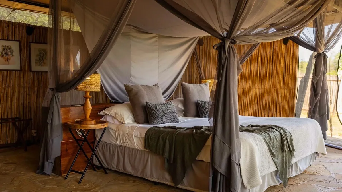 Four-poster bed in a tented suite, Roho ya Selous, Nyerere