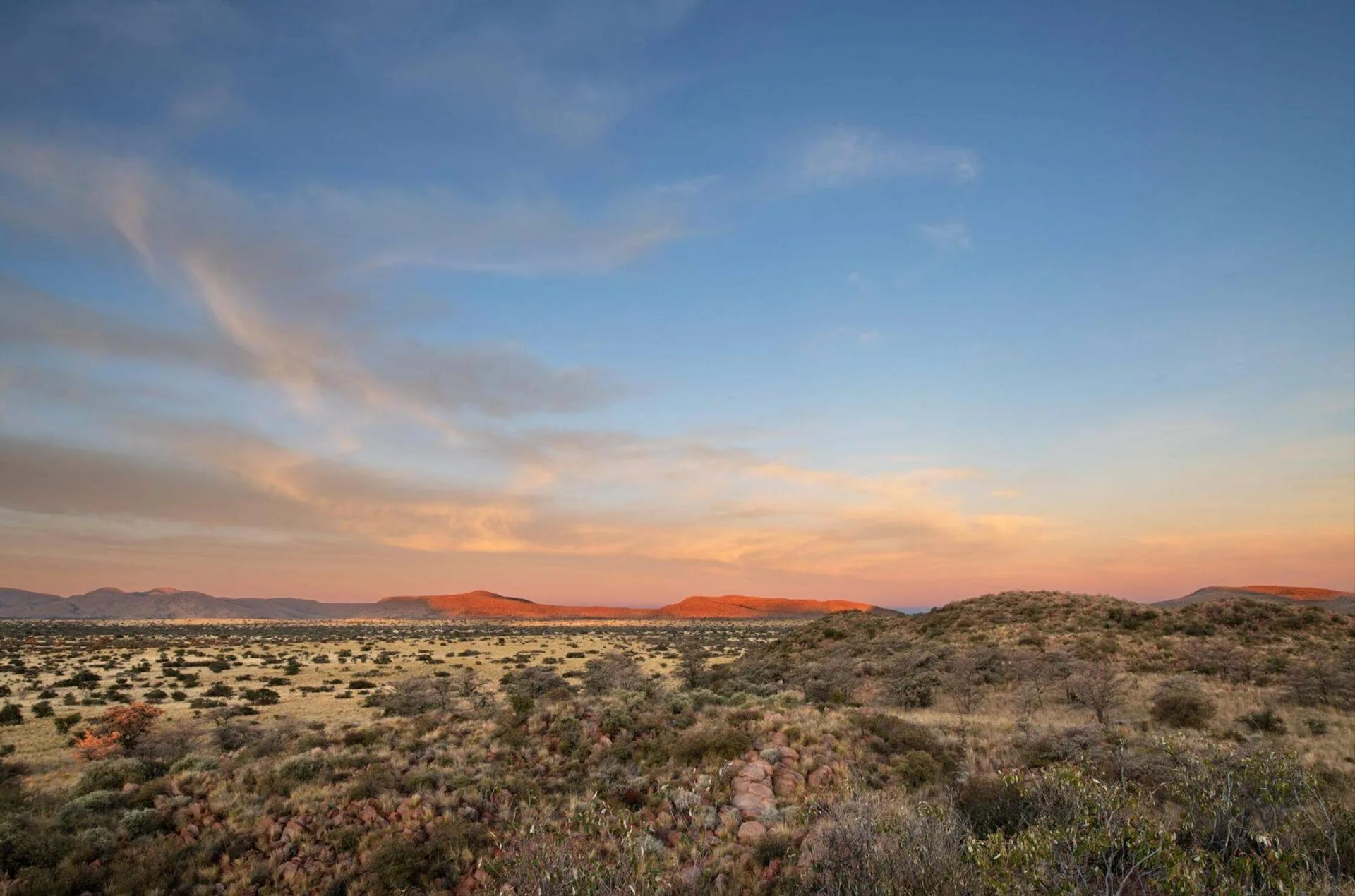 Red Kalahari dunes and the Korannaberg hills at dusk, Tswalu Kalahari Reserve, Northern Cape