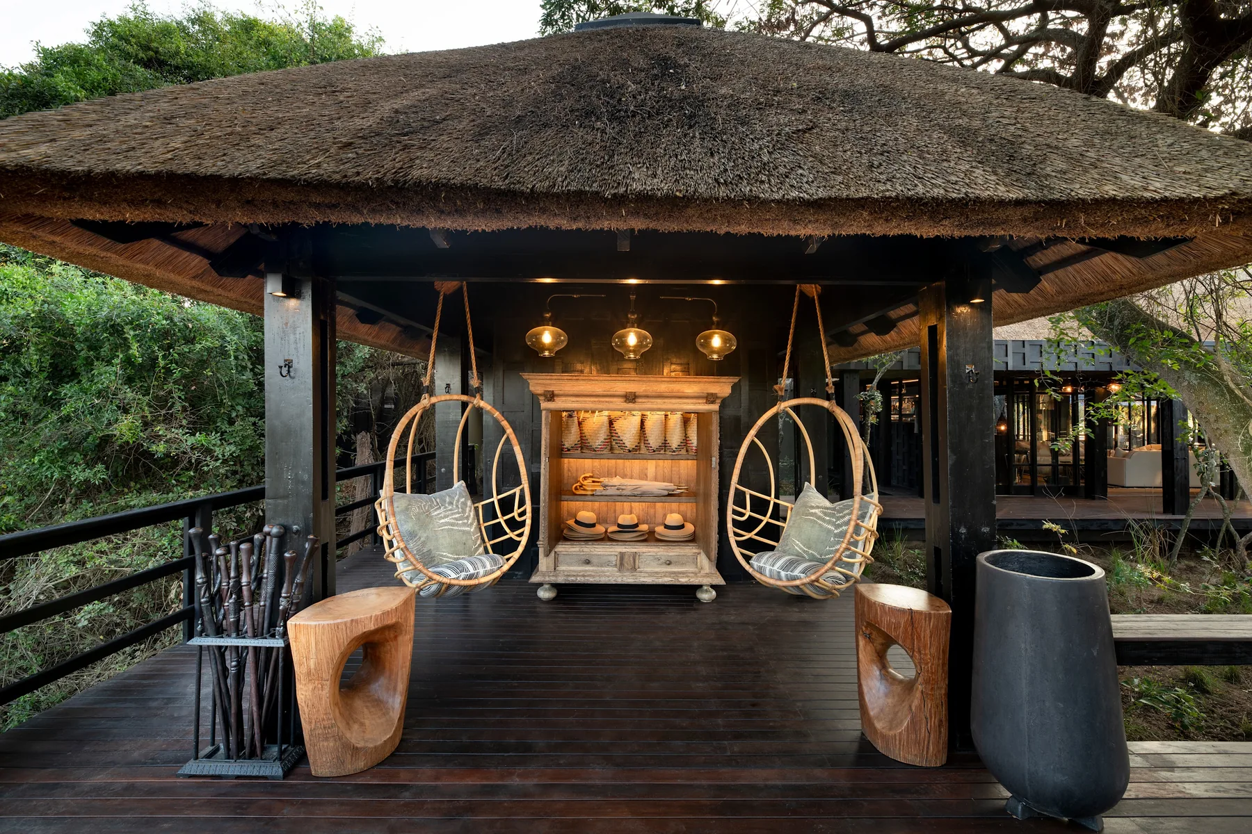 Arrival deck with hanging cane chairs and a cabinet of woven baskets and walking sticks, andBeyond Phinda Vlei Lodge