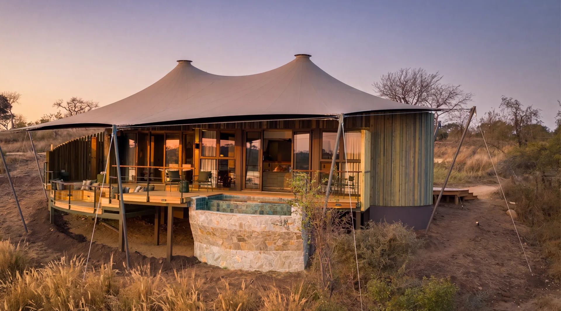 N'weti Camp canvas suite lit at dusk with private plunge pool, Sandringham Private Game Reserve, Greater Kruger